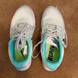 silver and teal Nike shoes